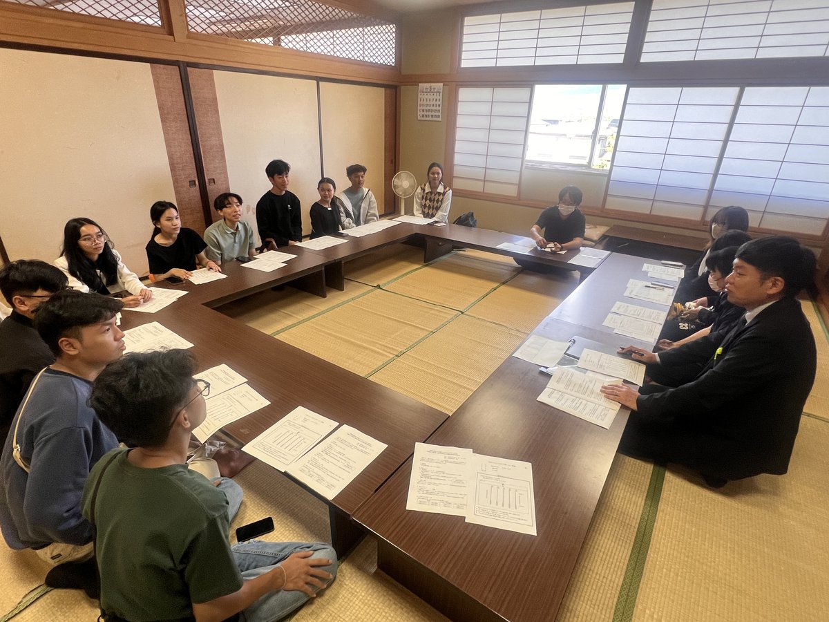 Participants in formal meeting with local government and business partners